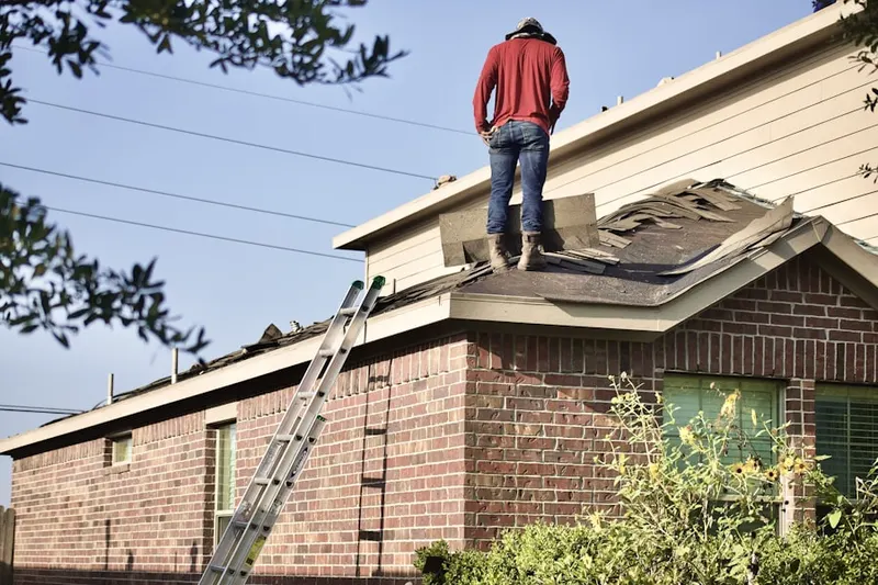 Professional roofer working on a residential roof in Scrapetown